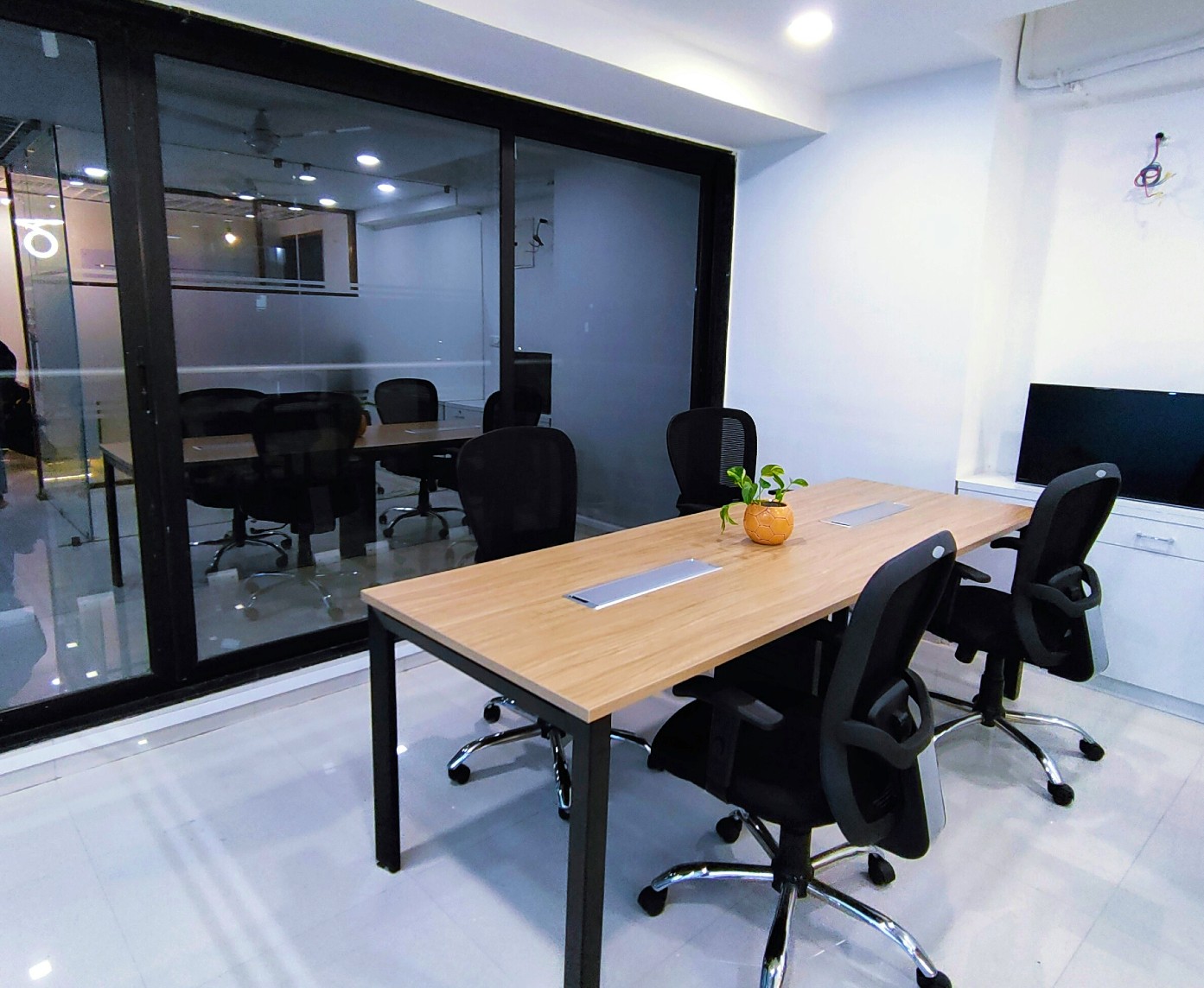 A room in an office building made by separating space with a glass partition wall.